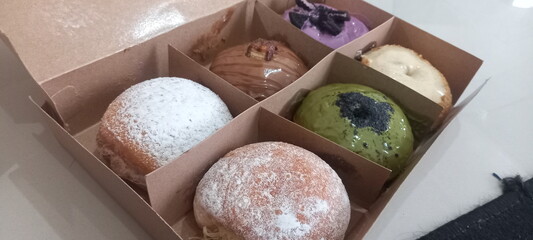 Donuts without a hole in the middle with various toppings