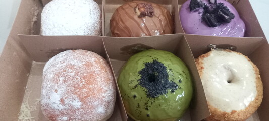 Donuts without a hole in the middle with various toppings