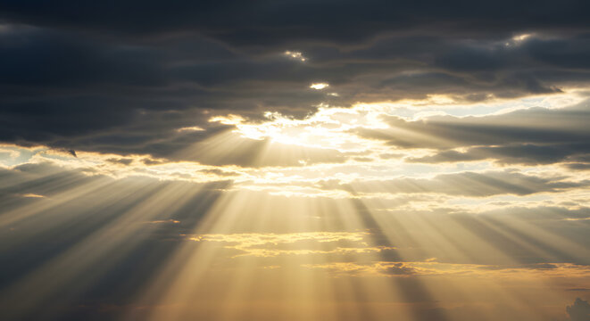 A radiant golden sunset, with the sun's brilliant light diffusing through hazy clouds, creating a soft yet powerful light across the sky.	