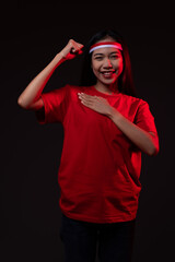 Fototapeta premium Portrait of Excited Young Asian Woman Wearing Red Outfit, Indonesian Independence Day Concept