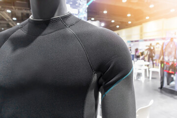A diving or scuba diving suit is worn on a mannequin in a shop, with a perspective that emphasizes the torso and shoulders.