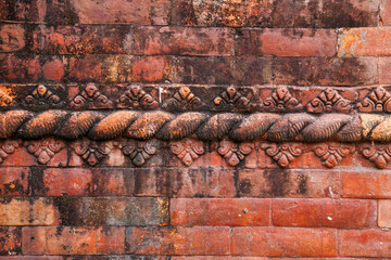 Intricately Carved Brick Wall Detail in Kathmandu, Nepal