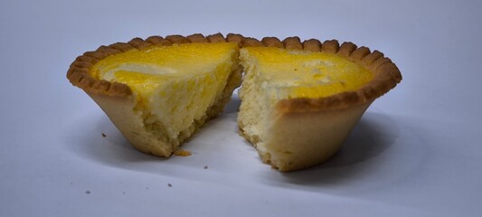 Egg tarts that are crispy on the outside and soft on the inside. Egg tarts that have a rich and creamy egg aroma. Egg tarts on white background.