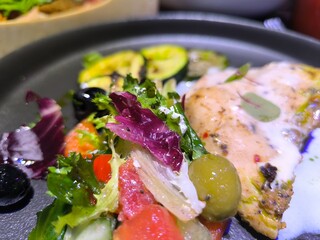 chicken breast baked with eggplant pieces and vegetables in a frying pan