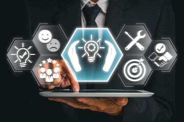 Businessman using a tablet with futuristic icons representing tailored solutions, customization,...