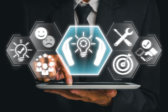 Businessman using a tablet with futuristic icons representing tailored solutions, customization, and strategic planning.
