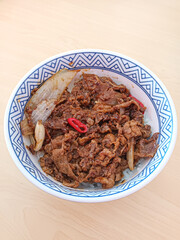 Delicious Japanese Gyudon Beef Bowl with Rice and Chili Pepper