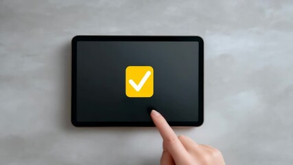 Digital Confirmation: A close-up shot captures a person's fingertip interacting with a tablet screen, highlighting a yellow checkmark symbol, which signifies validation or approval. - Powered by Adobe