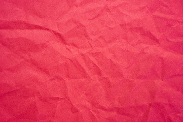 Fototapeta premium Full frame shot of crumpled red paper sheet texture and background.