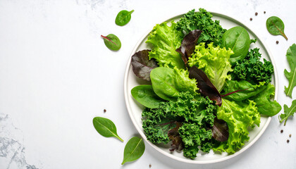 Obraz premium Top view of a plate of fresh leafy vegetables and white background. The concept of a healthy diet.