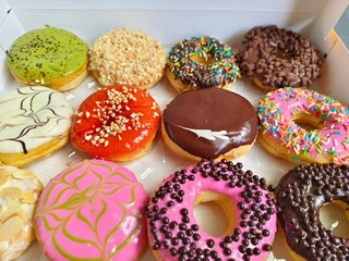 donuts are topped with different glazes, sprinkles, and patterns