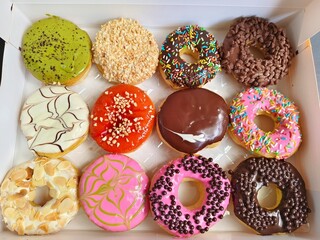 donuts are topped with different glazes, sprinkles, and patterns