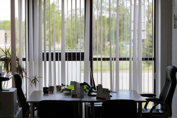Office Interior With Desk and Chairs by Large Window View