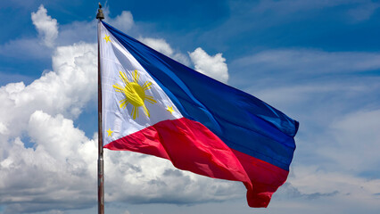 Philippine flag flying proudly against blue sky