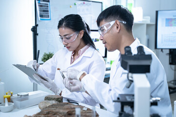 Scientist in laboratory conducting medical research using modern science and technology while...