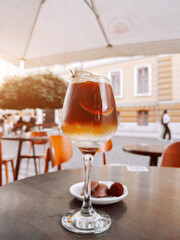 Enjoying cold coffee with lime and ice cubes in a vibrant outdoor cafe setting