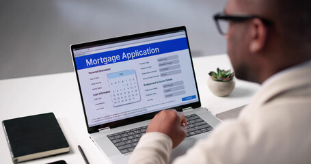 Online Mortgage Application: Young African American Man Approves