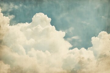 Vintage clouds fill the sky with a soft blue hue, providing ample copyspace for creative design or textual overlay in a serene atmospheric setting