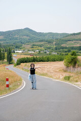 Fototapeta premium Woman Posing on Winding Country Road