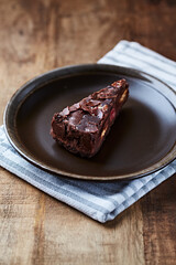 Piece of chocolate cake on rustic background. 