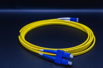 Yellow Fiber Optic Cable with Blue LC Connectors Coiled