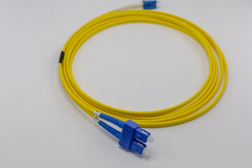 Close Up of Yellow Fiber Optic Cable with Blue Connectors