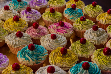 Colorful Glitter Cupcakes with Cherries on Top in a Festive Display