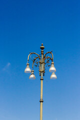 Elegant Street Lamp with Ornate Design Against a Clear Blue Sky