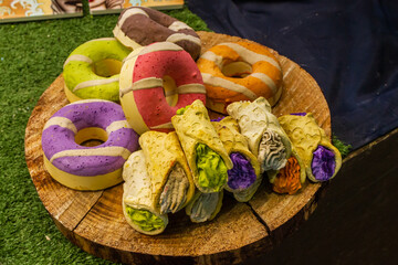 Colorful Pastry-Like Bath Bombs Displayed Creatively on a Wooden Stand