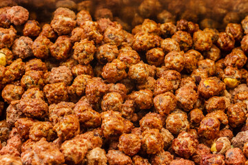 Close-Up of Glazed Sweet Nuts Displayed in a Nuts Section