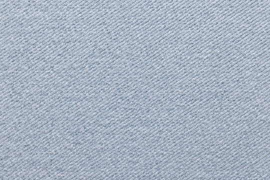 Blue denim fabric, for jackets, trousers and other clothes, close-up. Background, texture