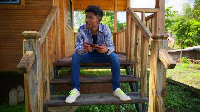 Day tripper entertains self with phone by stairs