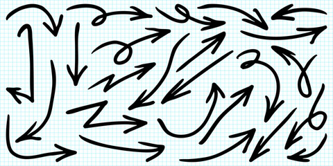 set of hand drawn doodle arrows in various styles on a blue grid paper background. 