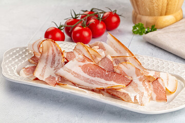 Raw pork tenferloin with bacon