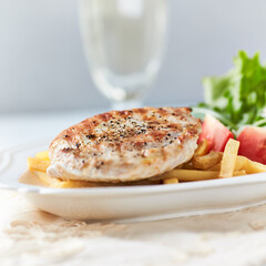 Grilled Turkey Breast with fresh salad. Bright background.	