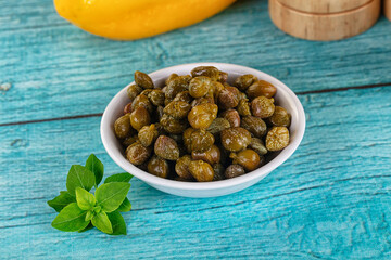 Pickled canned capers in the bowl