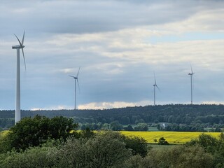 Panoramic view of wind farm or wind park, with high wind turbines for generation electricity in Hesse Germany near Huenfeld. Green energy concept.