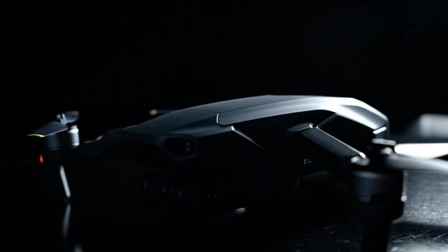 Close-Up Shot of Lit Drone Rotating on Table with High Contrast Lighting