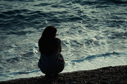 A lonely girl by the seaside

