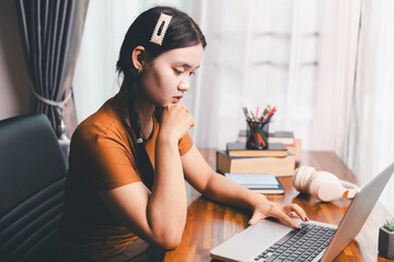 Homeschool Asian girl student learning virtual internet online class from school teacher by remote...