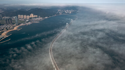 DJI Mavic 2 Pro HD aerial photography of Dalian Xinghai Bay Bridge under clouds and fog, Dalian, a second-tier city in Liaoning, China
