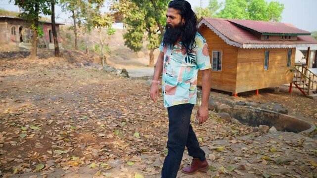 Bearded lawbreaker steps over muddy ground by retreat
