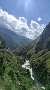 below cloud-capped peaks near Joshimath, India. Serene Himalayan landscape.