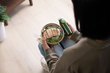 Asian woman holding healthy meal at workplace, Businesswoman having a lunch break at home office