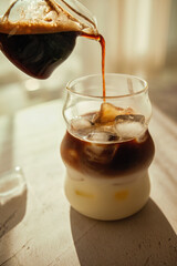 Sunlight and caffeine - this iced coffee layers rich espresso over milk with melting ice cubes,...