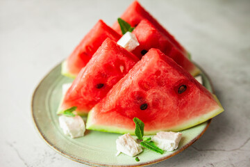 Refreshing slices of watermelon paired with crumbly feta cheese and mint leaves - a vibrant blend of textures and flavors that’s ideal for summer entertaining or healthy snacking.