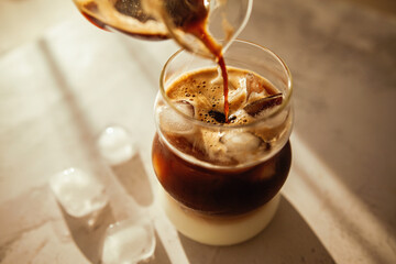 This iced coffee layers rich espresso over milk with melting ice cubes, perfect for slow mornings,...