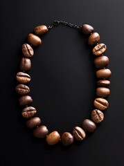 Obraz premium Crafted necklace of coffee beans showcasing creativity and unique design in an artistic arrangement against a dark background
