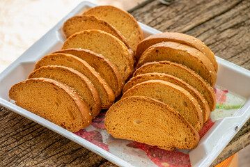 Crispy rusk, Biscuits cake rusk over wooden background , a crunchy snack infused with traditional spices, perfect for tea or coffee. A delightful treat for your mornings or tea time