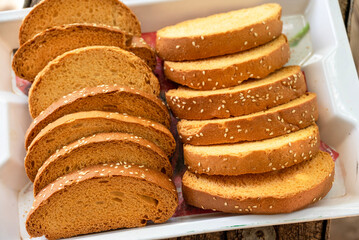 Crispy rusk, Biscuits cake rusk over wooden background , a crunchy snack infused with traditional spices, perfect for tea or coffee. A delightful treat for your mornings or tea time